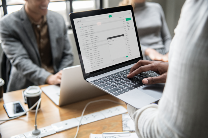 Man checking his email on a laptop looking at the email marketing metrics to track